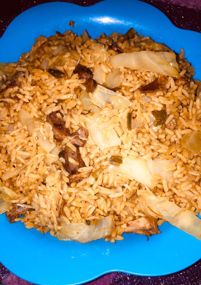 A picture of Jollof rice with cabbage.