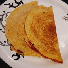 A picture of Pasta sauce cheese moong dal dosa.