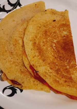 A picture of Pasta sauce cheese moong dal dosa.