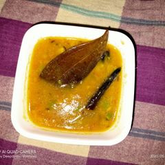 A picture of Arhar dal with raw mango.