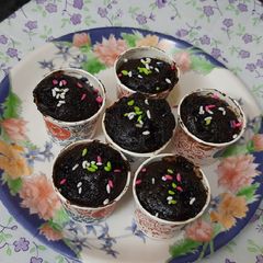 A picture of Chocolate cup cakes with harshley Syrup and choco chips.