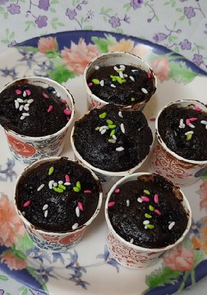 A picture of Chocolate cup cakes with harshley Syrup and choco chips.