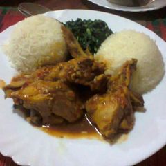 A picture of White Rice served with Curry chicken and vegetables.