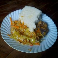 A picture of Ugali with fried cabbage and stewed meat.