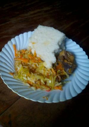 A picture of Ugali with fried cabbage and stewed meat.
