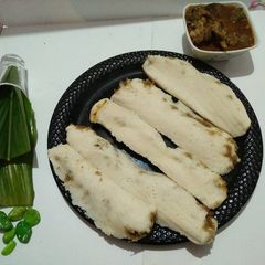 A picture of Coconut stuffed haldi patra(turmeric leaves) pitha.