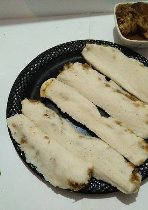 A picture of Coconut stuffed haldi patra(turmeric leaves) pitha.