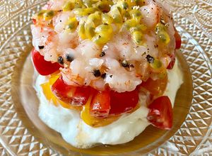Foto di Tartare di gamberi rossi con maracuja su burrata e datterini rossi e gialli