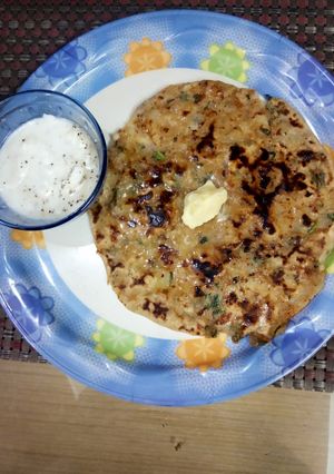 A picture of Aloo Paratha with Masala Yoghurt.