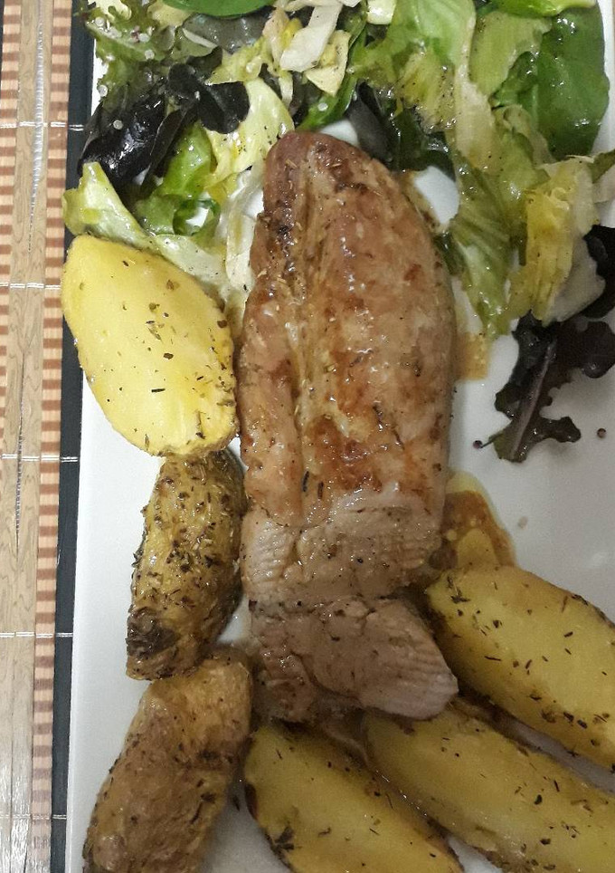 Una foto de Solomillo de cerdo al horno con patatas gajos especiada y asada