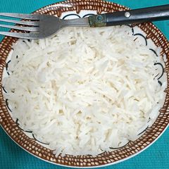 A bowl Of Steaming Hot Basmati Rice In A Pressure Cooker A picture of A bowl Of Steaming Hot Basmati Rice In A Pressure Cooker.