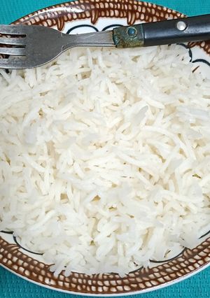 A picture of A bowl Of Steaming Hot Basmati Rice In A Pressure Cooker.