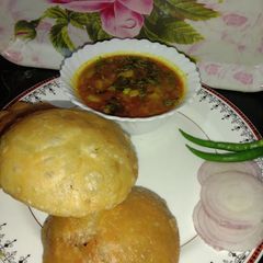 A picture of Stuffed Kachauri with aloo sabzi.