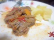 Una foto de lengua con cebollas y zanahoria