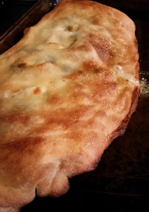 A picture of Brad's Margherita style calzone with chicken, artichoke, & ranch.