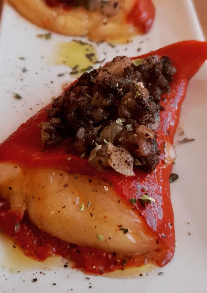Una foto de Pimientos piquillo rellenos de provolone con morcilla y manzana