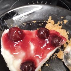 A picture of Vanilla cheesecake with cherry 🍒 topping.
