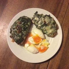 A picture of Spinach Toast with bleu cheese and eegs.