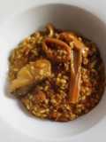 Arroz meloso de bacalao, calamar, ajos tiernos y alcachofas
