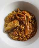 Arroz meloso de bacalao, calamar, ajos tiernos y alcachofas