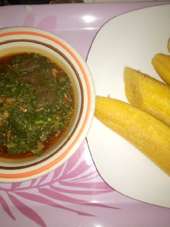 A picture of Boiled plantain and green vegetable sauce.
