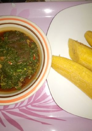 A picture of Boiled plantain and green vegetable sauce.