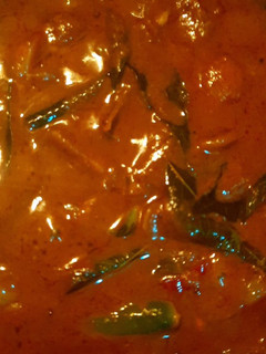 A picture of Ulli theeyyal (shallots cooked in roasted coconut gravy and tamarind juice).
