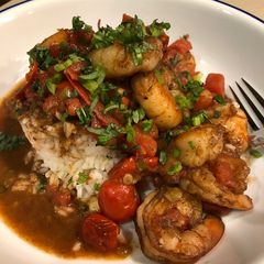 A picture of Spiced Ginger Shrimp with Burst Tomatoes.