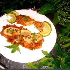 A picture of Rolled chicken breast stuffed with rice and spinach.