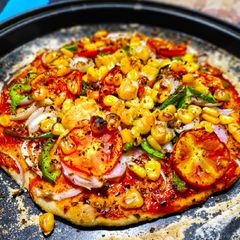 Thin crust veggies loaded pizza A picture of Thin crust veggies loaded pizza.