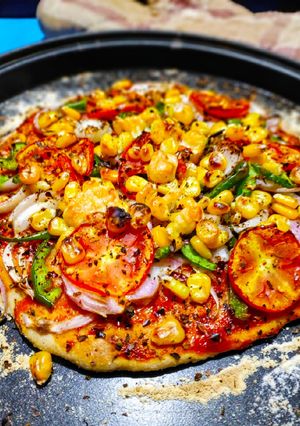 A picture of Thin crust veggies loaded pizza.