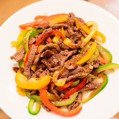 A picture of Stir-fried beef and paprika with lemon.