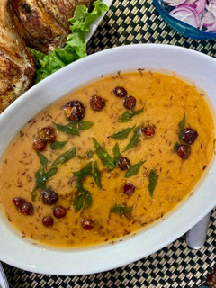 A picture of Sweet and sour Tomato Curry serve with white rice.