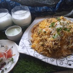 A picture of Chicken dam biryani with namkeen lassi.