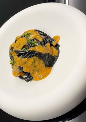 A picture of Squid Ink Spaghetti, Shellfish Butter, Sea Urchin Cream, and Gremolata.