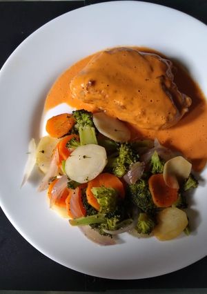 Una foto de Suprema rellena con mousse falso de nuez y verduras papillot