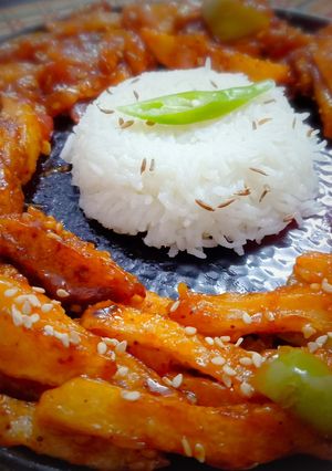 A picture of Schezwan Chilli Potatoes with Jeera Rice.