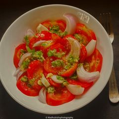 A picture of White Wine Vinegar on Tomato Salad.