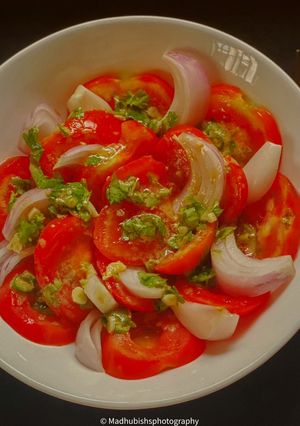 A picture of White Wine Vinegar on Tomato Salad.