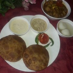 A picture of Chana dal puri rice kheer & sarsaw ki chutni aalu govi ki subji.
