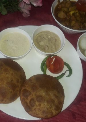 A picture of Chana dal puri rice kheer & sarsaw ki chutni aalu govi ki subji.