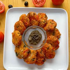 A picture of TOMATOKEFTEDES (Greek tomato fritters) served witholive paste (Tapenade).