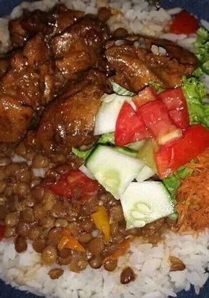 A picture of Lentil peas and rice, with salad.