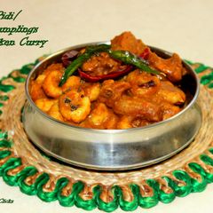 A picture of Kozhi Pidi/Rice Dumplings in Chicken Gravy.