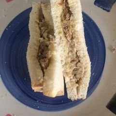 A picture of Bread sandwich with sardines fried in eggs.