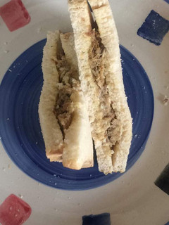 A picture of Bread sandwich with sardines fried in eggs.