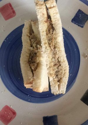 A picture of Bread sandwich with sardines fried in eggs.