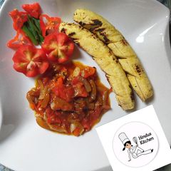A picture of Roasted plantain with ponmo (kpomo) sauce.
