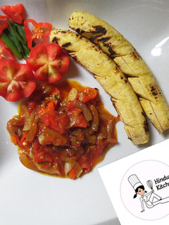 A picture of Roasted plantain with ponmo (kpomo) sauce.