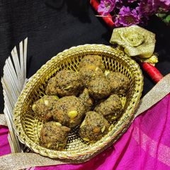 A picture of Wheat flour seeds and nuts Ladoo with leftover ghee residue.